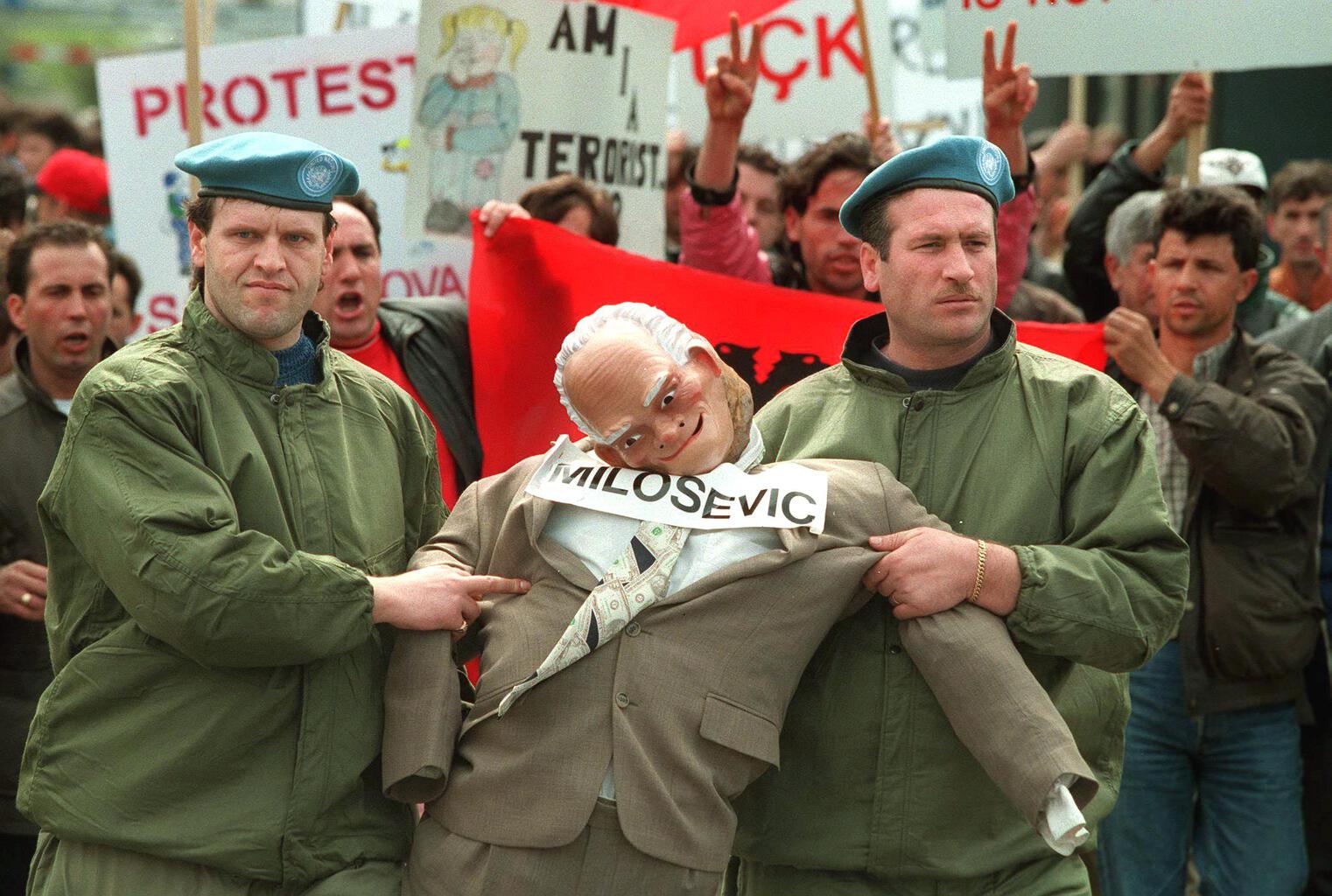 Két albán ENSZ békefenntartó egy életnagyságó Milosevics bábút visz egy tüntetésen Pristinában, 1998. április 24-én #moszkvater